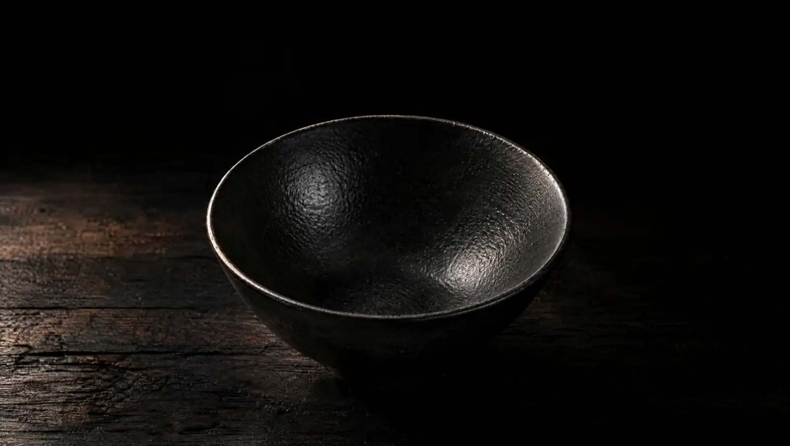 The empty black bowl on the counter.